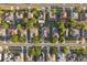 Aerial view showcasing a neighborhood with well-maintained homes, mature trees, and a grid-like street layout at 600 Rob Roy Dr, Clermont, FL 34711