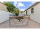 Charming brick-paved backyard patio featuring a quaint bird bath and garden area at 600 Rob Roy Dr, Clermont, FL 34711