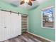 Bedroom features wood floors, sliding barn door closet and window at 600 Rob Roy Dr, Clermont, FL 34711