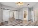 Bedroom boasting wood floors, a ceiling fan, and sliding barn door at 600 Rob Roy Dr, Clermont, FL 34711