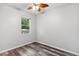 Bright bedroom showcasing wood floors and ample natural light from the window at 600 Rob Roy Dr, Clermont, FL 34711