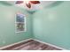 Bedroom featuring wood floors and natural light from the window at 600 Rob Roy Dr, Clermont, FL 34711