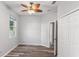 Neutral bedroom showcasing wood floors, ceiling fan, and ample natural light from the window at 600 Rob Roy Dr, Clermont, FL 34711