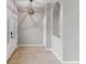 Bright entryway with tile flooring, decorative niche, and stylish geometric pendant lighting at 600 Rob Roy Dr, Clermont, FL 34711