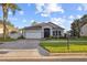 Charming home featuring beautiful landscaping, a well-maintained lawn, and a brick driveway at 600 Rob Roy Dr, Clermont, FL 34711