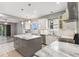 Modern kitchen with white cabinets, stainless steel appliances, granite counters, and a center island at 600 Rob Roy Dr, Clermont, FL 34711