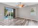 Living room features wood flooring and a large sliding glass door leading to the pool at 600 Rob Roy Dr, Clermont, FL 34711