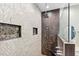 Modern shower featuring stone accents, a shower head, and tiled walls at 600 Rob Roy Dr, Clermont, FL 34711