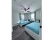 Cozy bedroom with matching twin beds, ceiling fan, and soft, neutral decor at 637 Ash Ave, Daytona Beach, FL 32117