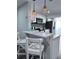 Bright kitchen featuring white cabinets, stainless steel appliances, and a breakfast bar at 637 Ash Ave, Daytona Beach, FL 32117