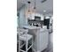 Bright kitchen featuring white cabinets, stainless steel appliances, and a stylish breakfast bar at 637 Ash Ave, Daytona Beach, FL 32117