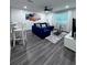 Bright living room with modern decor, a comfortable blue sectional, and sleek flooring at 637 Ash Ave, Daytona Beach, FL 32117
