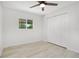 Clean bedroom with luxury vinyl plank flooring, window, ceiling fan and closet at 6426 Sw 60 Ave, Ocala, FL 34474
