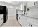 Modern kitchen featuring white cabinets, granite countertops, and stainless steel appliances at 6426 Sw 60 Ave, Ocala, FL 34474