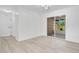 Bright open living area featuring luxury vinyl plank flooring and sliding glass door to outdoor patio at 6426 Sw 60 Ave, Ocala, FL 34474