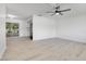 Bright and airy living room showcasing stylish floors, white walls, fan, and seamless flow to outdoor patio at 6426 Sw 60 Ave, Ocala, FL 34474