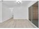 Bright living room featuring wood-look floors, modern lighting, and sliding glass door access at 6426 Sw 60 Ave, Ocala, FL 34474