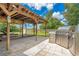 A large outdoor grill is next to an outdoor living space that is covered and has a wood deck at 6426 Sw 60 Ave, Ocala, FL 34474