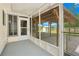 Inviting screened-in porch with a wooden deck and access to the backyard at 6426 Sw 60 Ave, Ocala, FL 34474