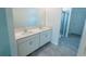 Bathroom features double vanity with quartz countertop and a glass-enclosed shower at 6442 Pine Warbler Way, St Cloud, FL 34771