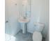 Compact powder room featuring a pedestal sink, toilet, and minimal decorative elements at 6442 Pine Warbler Way, St Cloud, FL 34771