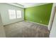 Bedroom showcases carpet and a green accent wall at 6442 Pine Warbler Way, St Cloud, FL 34771