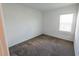 Empty bedroom with gray carpet and a window for natural light at 6442 Pine Warbler Way, St Cloud, FL 34771