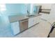 Contemporary kitchen island with stainless steel dishwasher and sink, surrounded by white cabinets at 6442 Pine Warbler Way, St Cloud, FL 34771