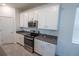 Well-equipped kitchen with stainless steel appliances, stylish countertop, and white cabinets at 6442 Pine Warbler Way, St Cloud, FL 34771