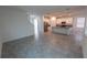 Expansive open-concept living space featuring gray tile and seamlessly connects to a modern kitchen at 6442 Pine Warbler Way, St Cloud, FL 34771