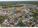 An aerial view of the home in a residential area near a pond, with lush greenery at 655 Eagle Pointe South, Kissimmee, FL 34746