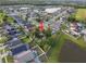 Aerial view of the neighborhood showing the home, surrounding houses, and nearby pond at 655 Eagle Pointe South, Kissimmee, FL 34746