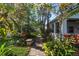 Landscaped path leading to the home with lush tropical plants at 655 Eagle Pointe South, Kissimmee, FL 34746