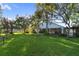 Sprawling backyard with mature trees and manicured lawn at 655 Eagle Pointe South, Kissimmee, FL 34746