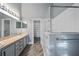 Modern bathroom featuring double vanity, glass shower, and walk-in closet at 655 Eagle Pointe South, Kissimmee, FL 34746