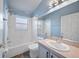 Compact bathroom featuring a tub-shower combo, toilet, and single sink vanity at 655 Eagle Pointe South, Kissimmee, FL 34746