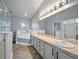 Bright bathroom with double sink vanity, glass shower and separate tub at 655 Eagle Pointe South, Kissimmee, FL 34746