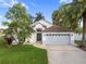 Charming single-story home with a well-manicured lawn, mature trees, and a two-car garage at 655 Eagle Pointe South, Kissimmee, FL 34746