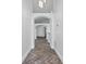 Hallway showcasing the arched entryway and herringbone flooring at 655 Eagle Pointe South, Kissimmee, FL 34746