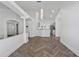 Spacious living room with stylish columns and herringbone floors leading to kitchen at 655 Eagle Pointe South, Kissimmee, FL 34746