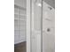 Close up of a white shower, with a white shower organizer and an organized closet at 655 Eagle Pointe South, Kissimmee, FL 34746