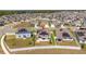 Aerial shot of a home with a large patio with outdoor furniture and solar panels at 6935 Dilly Lake Ave, Groveland, FL 34736