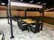 Outdoor dining and relaxing area under string lights on a paver patio and pergola in the backyard at 6935 Dilly Lake Ave, Groveland, FL 34736
