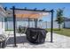 Secluded backyard offering a paved patio and lush greenery at 6935 Dilly Lake Ave, Groveland, FL 34736