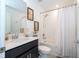 Well-lit bathroom with a shower over tub and modern vanity at 6935 Dilly Lake Ave, Groveland, FL 34736