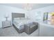 Luxurious bedroom featuring a tufted headboard, chandelier, and neutral color palette at 6935 Dilly Lake Ave, Groveland, FL 34736