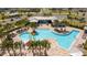Overhead view of the neighborhood community pool with splash pad and lounge area with palm trees at 6935 Dilly Lake Ave, Groveland, FL 34736