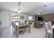 Stylish dining area with modern chandelier open to living room with entertainment center at 6935 Dilly Lake Ave, Groveland, FL 34736
