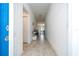 Bright hallway features tile flooring, white walls, and access to living spaces at 6935 Dilly Lake Ave, Groveland, FL 34736