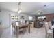 Open-concept living and dining area with modern furnishings and access to the outdoors at 6935 Dilly Lake Ave, Groveland, FL 34736